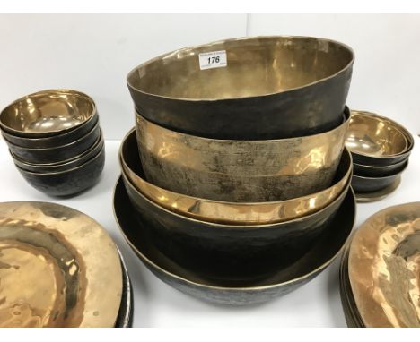 A collection of three beaten bronze deep bowls 28 cm diameter - 23.5 cm diameter, a collection of eleven smaller finger type 