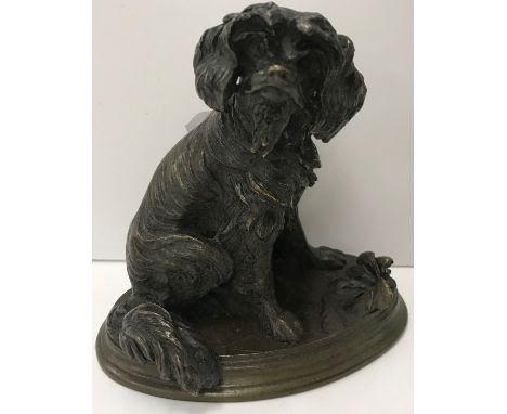 A bronze model of a King Charles Spaniel style dog, raised on an oval base, inscribed "J.Moigniez", 12 cm long x 11.5 cm high