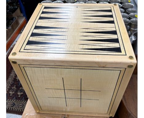 An Alison Henry game cube, each side printed with various games boards including backgammon, chess, noughts and crosses, etc,