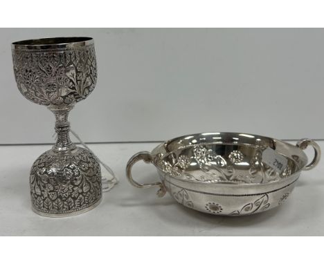 A George V silver wine taster in the French taste, the main bowl with foliate and floral embossed decoration flanked by two S