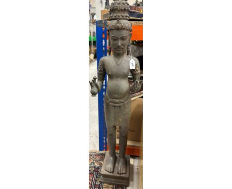 An Indonesian bronze figure of "A bearded Buddha with plaited top knot, holding a bottle in his right hand and bead bracelet 