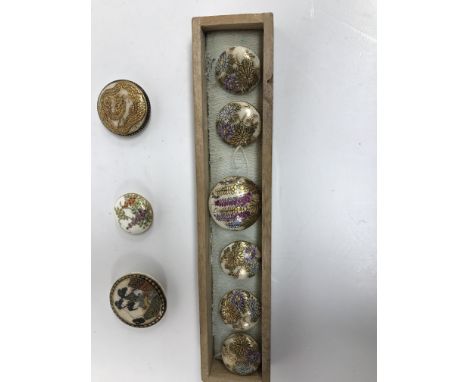 A set of five Satsuma buttons with chrysanthemum style decoration, together with a similar larger button set with labernum st