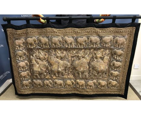 A Thai tapestry with black borders and design of elephants embroidered in various colours of gilt thread, 170 cm x 100 cm
