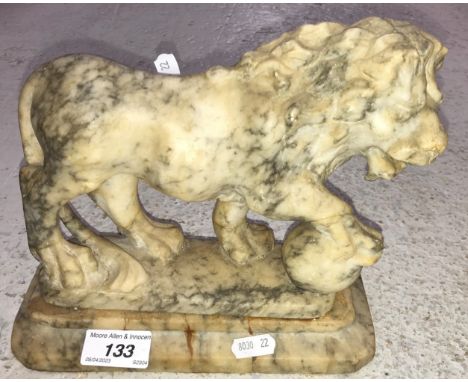 A carved marble figure of a lion with paw on ball on a plinth base 22 cm long x 20 cm high together with a brass framed conve