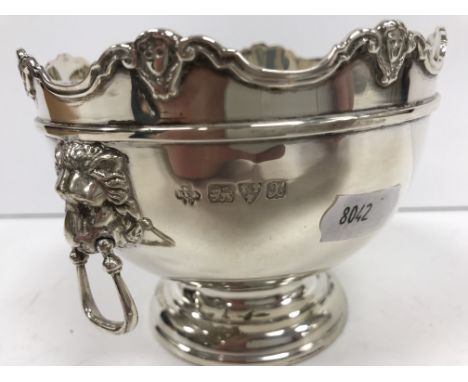 A George V silver sugar basin of rounded rectangular bellied form with beaded rim and plain open handles, raised on an oval f