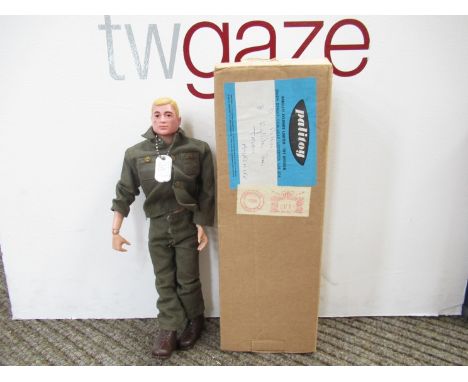 A Palitoy Action Man figure with moulded blonde hair in green army uniform, in original mail order box