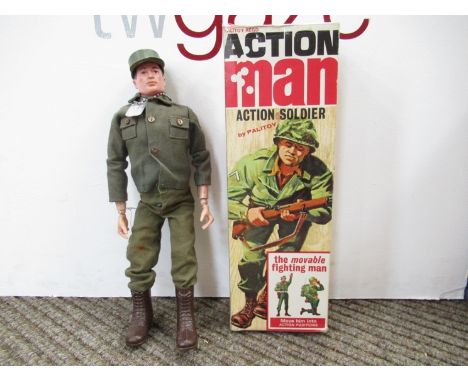 A boxed Palitoy Action Man Action Soldier figure with moulded brown hair in green army uniform with hat, boots and dog tag