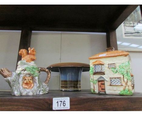 A cottage biscuit barrel, squirrel teapot and pottery bowl