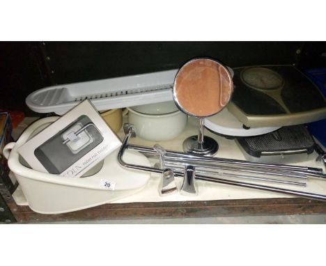 A shelf of bathroom items including ceramic bed pan