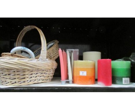 A shelf of baskets and candles