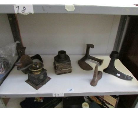 A shelf of shoe lasts, coffee grinder