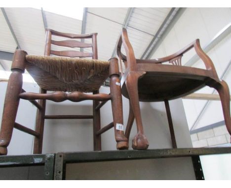 A ladder back chair and an elbow chair on ball and claw feet