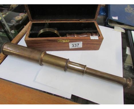 A cased brass telescope with magnifying glass