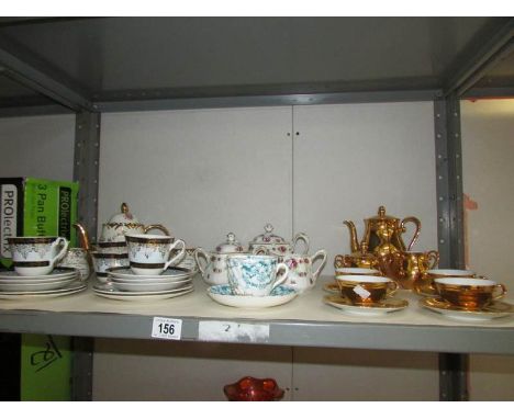 A shelf of assorted tea ware