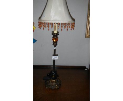 A table lamp with beaded shade