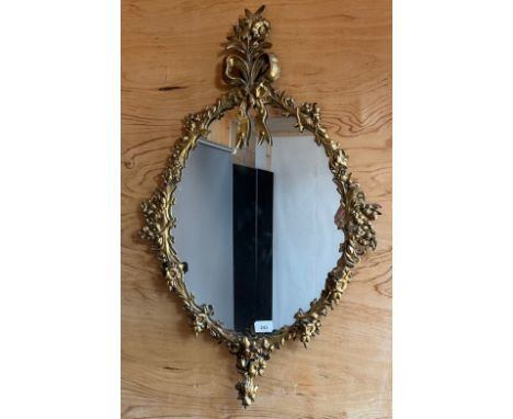 Antique Regency mirror, the moulded brass gilt frame surmounted by a floral and bow design [84x52cm] 