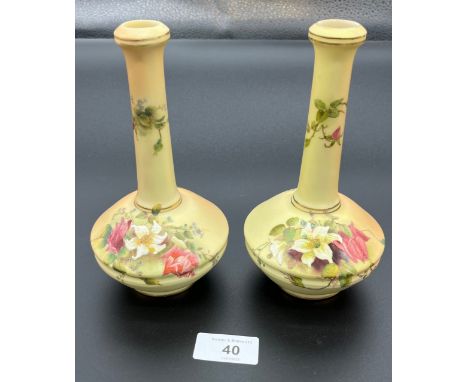 A Pair of blush ivory and hand painted bottle neck vases produced by Royal Worcester. [18cm high] 