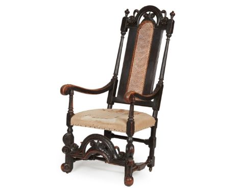 William and Mary Walnut armchair 17th century, the tall back with an arched and pierced moulded crest above a caned back flan