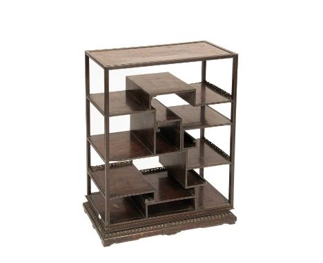 A Chinese rosewood set of display shelves, with some carved gallery edges, on a carved plinth, 71cm wide, 28cm deep, 91.5cm h