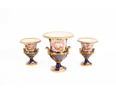 A garniture of three English porcelain urns, decorated with panels of flowers within gilt borders on a blue-scale ground, the