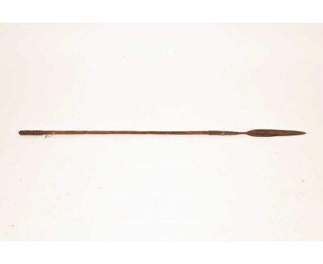 An African Spear (likely Zulu) 19th Century, the handforged iron spearhead with a cane-wrapped head and spiral steel-wrapped 
