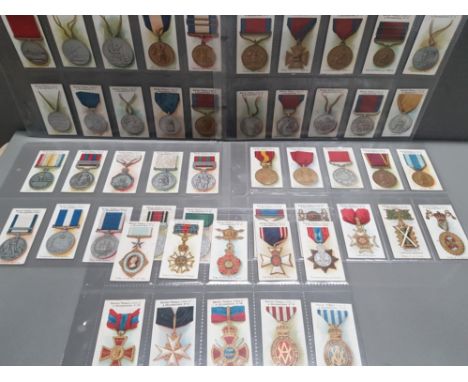COMPLETE SET OF 50 1912 TADDYS CIGARETTE CARDS BRITISH MEDALS AND DECORATIONS IN GOOD CONDITION WITH LIGHT TONING ON SOME