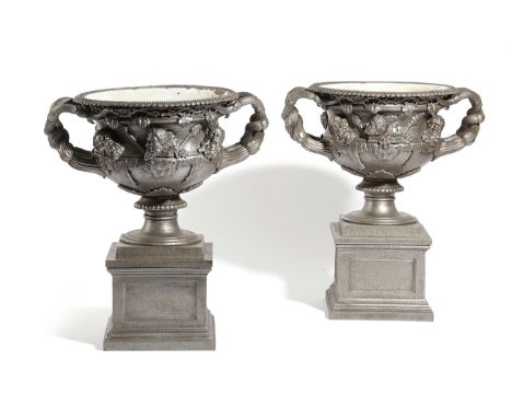 A PAIR OF POLISHED CAST IRON MODELS OF THE WARWICK VASE AFTER THE ANTIQUE, LATE 19TH CENTURY each decorated with entwined han