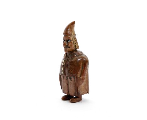 A CARVED COQUILLA NUT FIGURAL SNUFF BOX POSSIBLY FRENCH, LATE 18TH / EARLY 19TH CENTURY with glass eyes, a hooked nose and wi