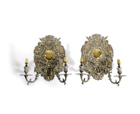 A SET OF FOUR SILVERED BRASS TWIN-LIGHT WALL LIGHTS IN CHARLES II STYLE EARLY 20TH CENTURY each decorated with winged cherubs