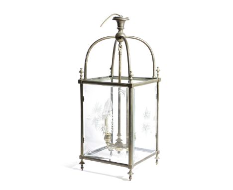 A BRASS AND CUT-GLASS HALL LANTERN with four star-cut and bevelled panes, beneath an arched frame, supporting four lights 74c