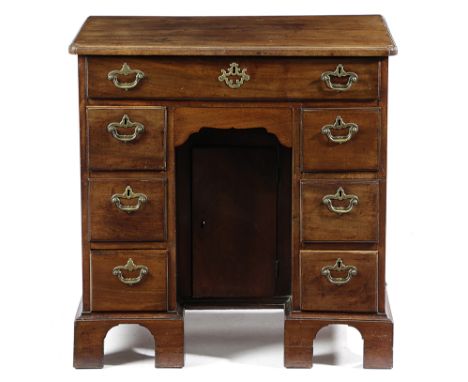 A GEORGE II MAHOGANY KNEEHOLE DESK C.1750 the caddy moulded top above an arrangement of eight drawers, surrounding a central 