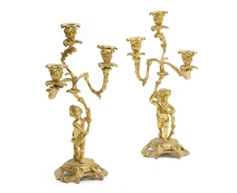 A PAIR OF FRENCH ORMOLU THREE-LIGHT CANDELABRA IN LOUIS XV STYLE 19TH CENTURY each modelled with a cherub, supporting a branc