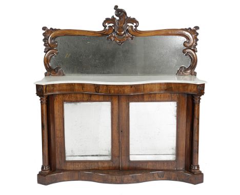 λ A VICTORIAN ROSEWOOD SERPENTINE SIDE CABINET C.1850-60 with a raised mirror back, above a marble top and a pair of mirror d