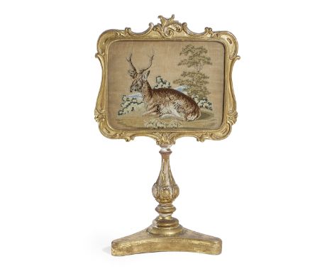 A VICTORIAN TAPESTRY TABLE SCREEN MID-19TH CENTURY with a needlework picture depicting a recumbent deer, in a rectangular gil