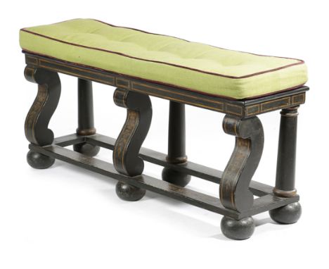 AN EBONISED WOOD HALL BENCH 20TH CENTURY with parcel gilt decoration of leaves and flowers, on scroll front supports and bun 
