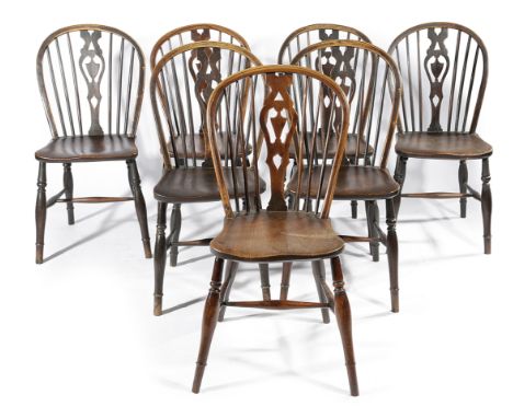 A HARLEQUIN SET OF SEVEN REGENCY ASH AND YEW WINDSOR KITCHEN CHAIRS LATE 18TH / EARLY 19TH CENTURY each with a hoop and stick