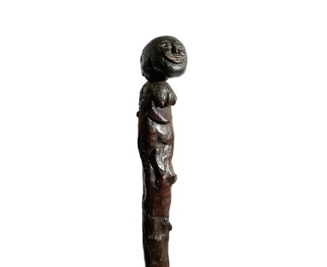 A FOLK ART FIGURAL WALKING STICK OR KNOBKERRIE 19TH CENTURY possibly yew, the carved wooden head with painted details, applie