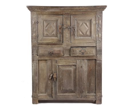 AN OAK LIVERY CUPBOARD 17TH CENTURY with a bog oak and holly chevron band and carved decoration, with a pair of lozenge panel