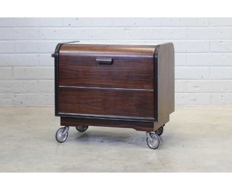 A French Art Deco drinks trolley,the top mounted with a mirrored panel, the Macassar ebony sides hinged to reveal compartment