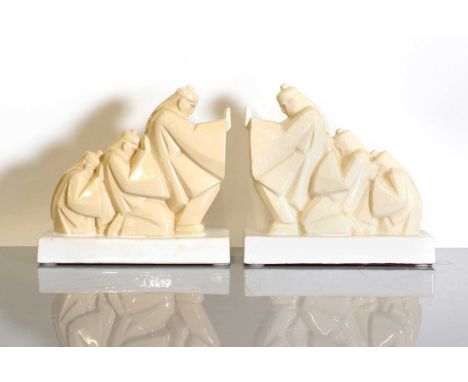 A pair of French Art Deco ceramic bookends,  1920s, by Argilor for Ochies, each modelled as a train of three Chinese men push