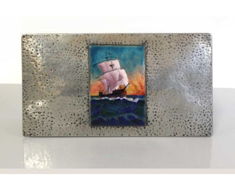 A Tudric pewter and enamelled cigar box,the hammered hinged cover, centred with an enamel plaque of a galleon in full sail wi