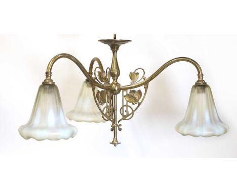 A brass three-branch ceiling light,in the manner of W A S Benson (1854-1924), with scrolled foliate decoration and moulded op