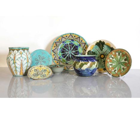 A collection of eight Della Robbia pottery items,1889-1900, comprising five plates, a bowl, a jardinière and a vase, all inci