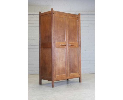 A Gordon Russell 'Stow' oak wardrobe, dated 1929, model no. 101, originally designed c.1925 by Gordon Russell, with a pair of