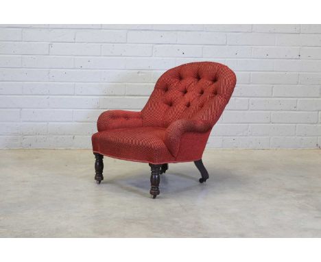 An upholstered chair on turned front legs and castors,c.1870, by Gillow &amp; Co., Lancaster, upholstered in red fabric throu