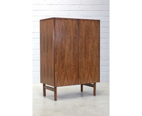 § A rosewood 'Kimberley' wine cabinet,1970s, designed by Robert Heritage for Archie Shine, with a pair of doors opening on to