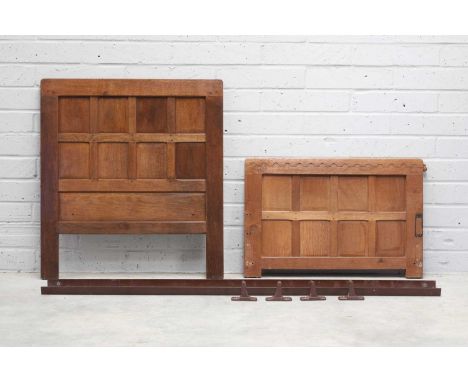 A pair of Robert 'Mouseman' Thompson oak single beds, 1930s, each with half-penny moulding to the headboard and footboard, wi