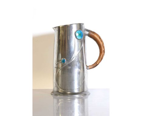 A Tudric pewter jug, designed by Archibald Knox for Liberty &amp; Co., with blue and green enamelled cabochons, with a woven 