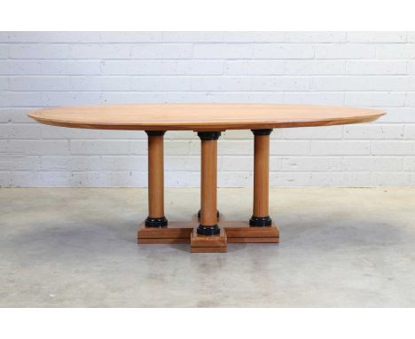 A Linley cherrywood dining table, designed by David Linley, in the Biedermeier taste, the oval banded top raised on four colu