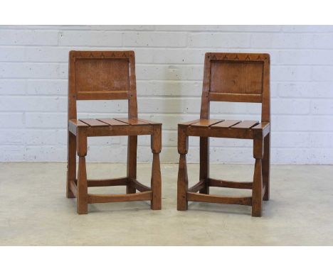 A pair of Thomas 'Gnomeman' Whittaker oak side chairs, 1950s, each with a panelled backrest over a slatted seat, the top of t